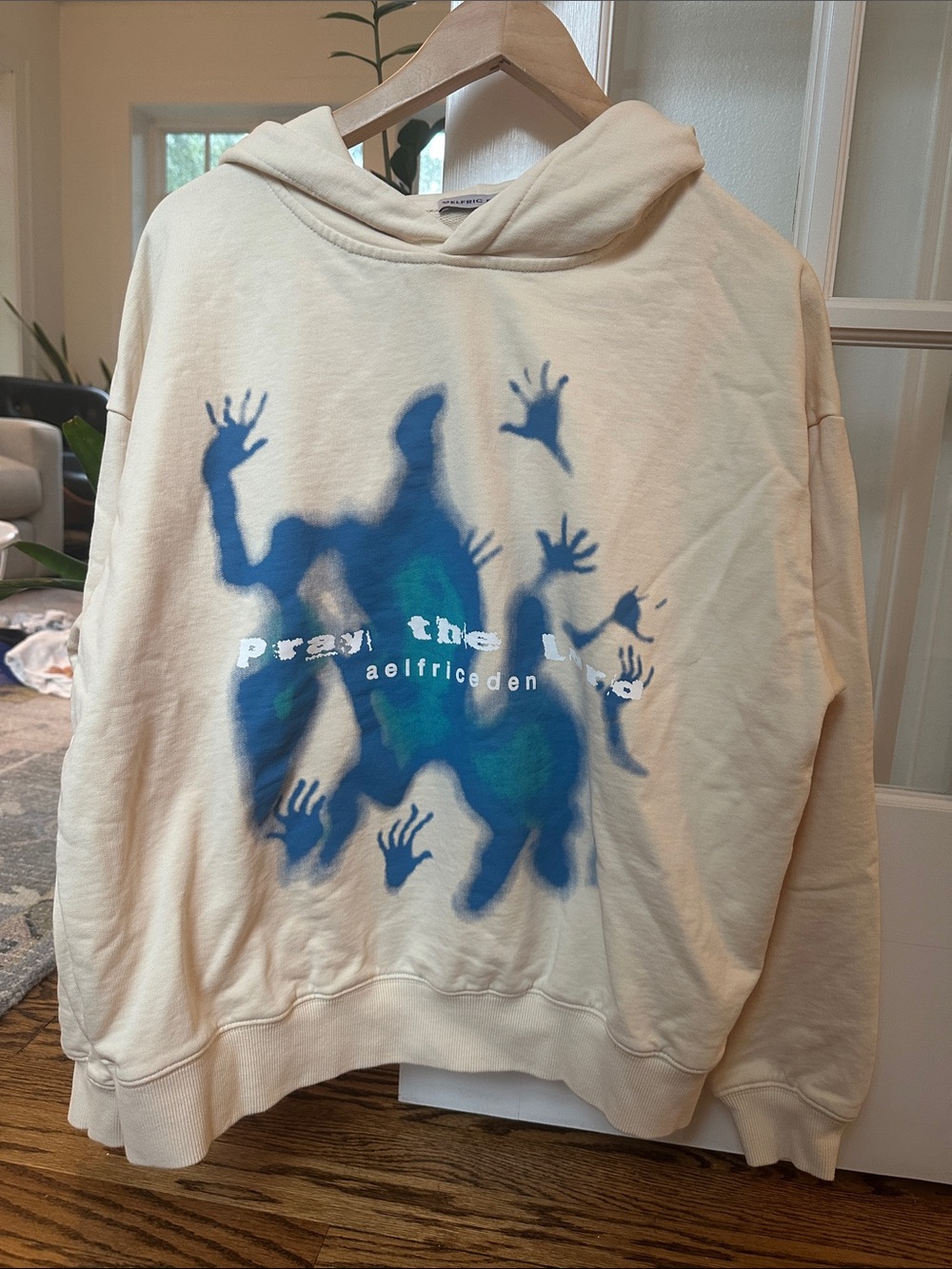 Aelfric Eden Cream Crewneck Hoodie with Blue-Green Graphic